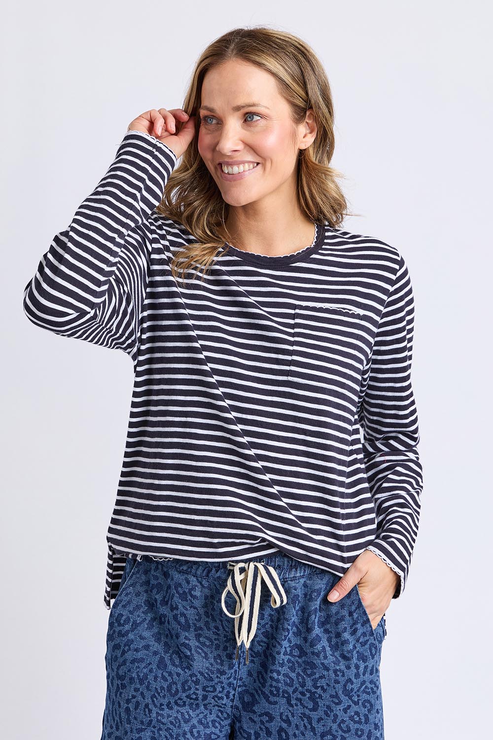 A model wearing the Drea Cotton Long Sleeve Tee in colour Navywhite, from the front, cropped image