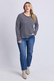 A model wearing the Drea Cotton Long Sleeve Tee in colour Navywhite, from the front, showing the whole outfit