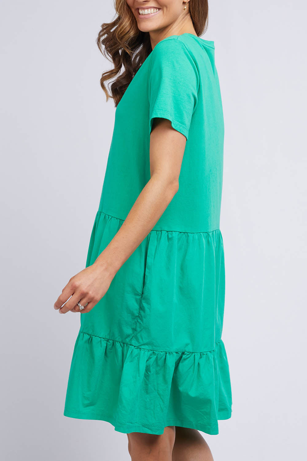 A model wearing the Joanna Tee Dress in colour Green (Green), from the back