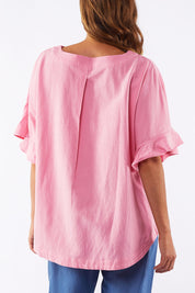 A model wearing the Miranda Top in colour Bubblep (Pink), from the back