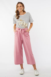 A model wearing the Dylan Wide Leg Pant in colour Rose (Pink), from the front, showing the whole outfit