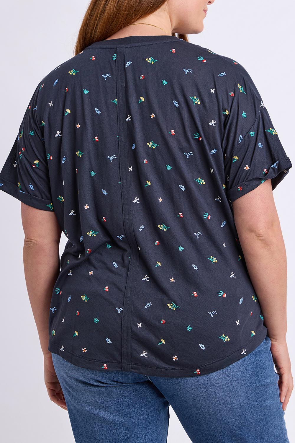 Model Genericm wearing size sample of the Festive Market Tee – Navy in colour Navy, from the back