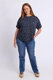 Model Genericm wearing size sample of the Festive Market Tee – Navy in colour Navy, from the front