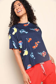 Model Pamelar wearing size 10 of the Market Tee – Navy in colour Navy, from an angle