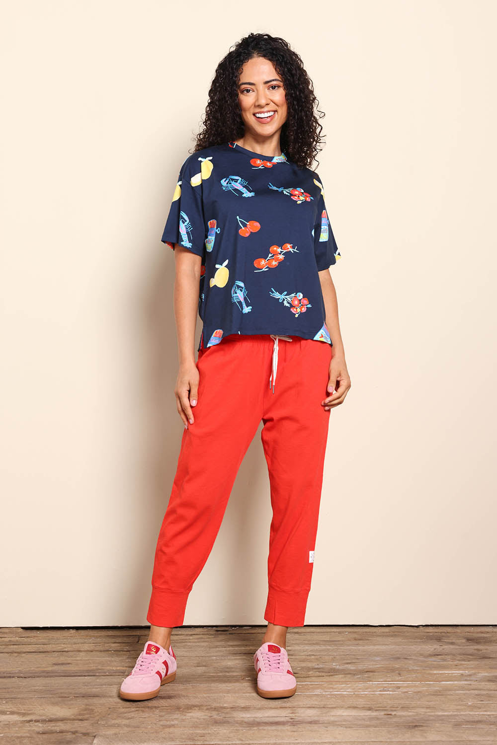 Model Pamelar wearing size 10 of the Market Tee – Navy in colour Navy, from the front