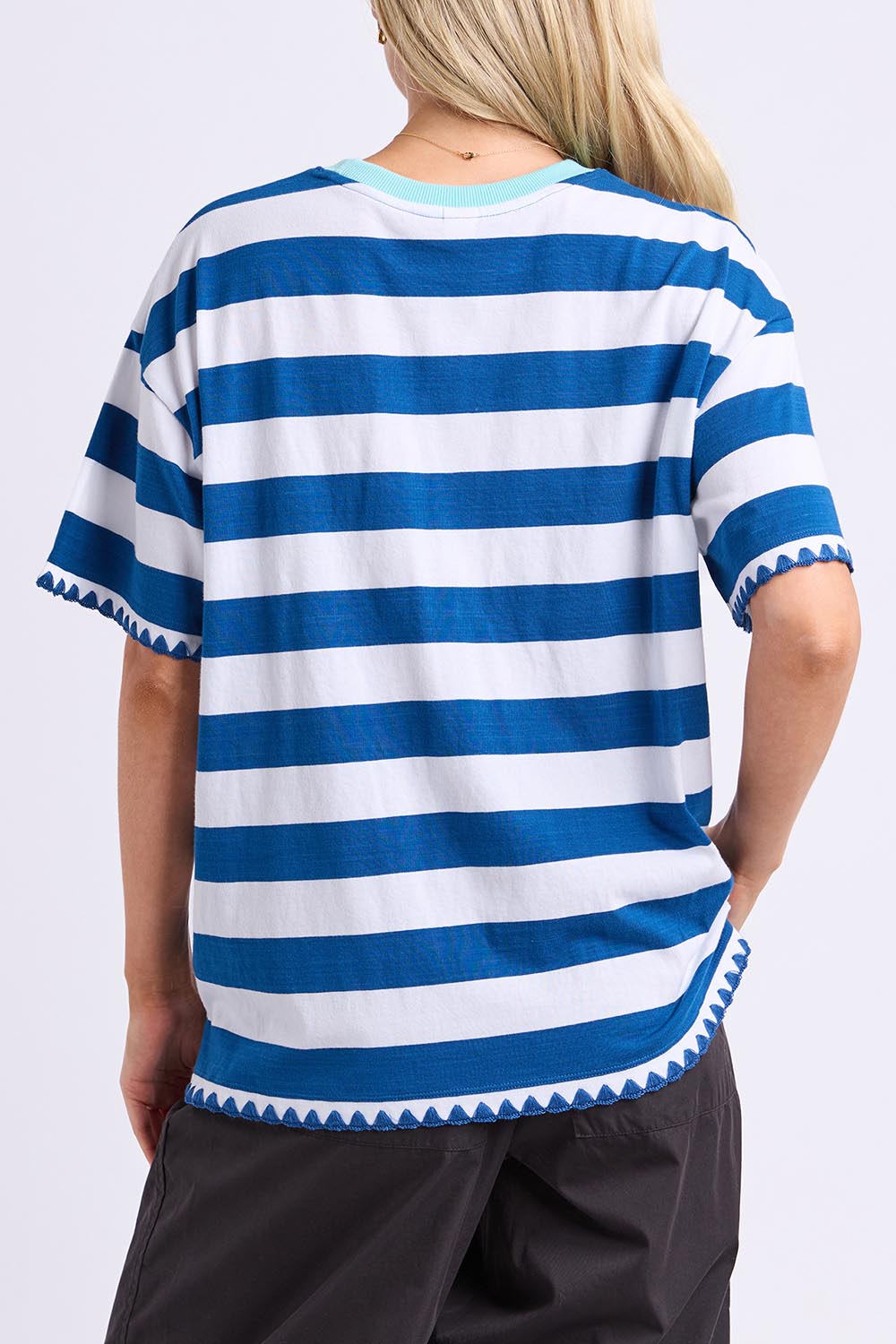 Model Genericm wearing size sample of the Cherry Tee – Chinablue in colour Chinablue, from the back