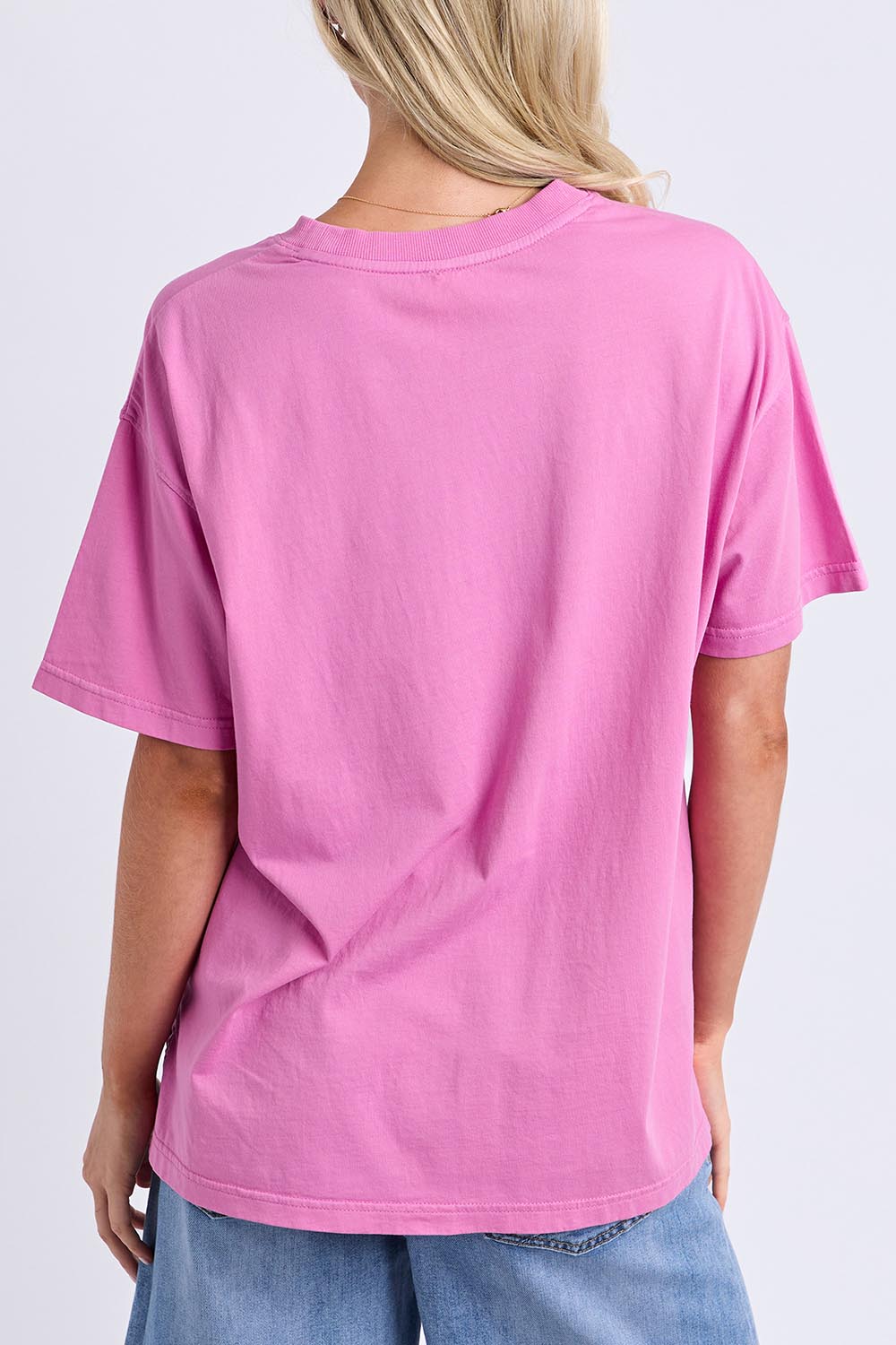 Model Genericm wearing size sample of the Rio Tee – Magenta in colour Magenta, from the back