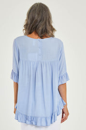 Model Luisa wearing size 10 of the Kiara Top in colour Skyblue (Blue), from the back