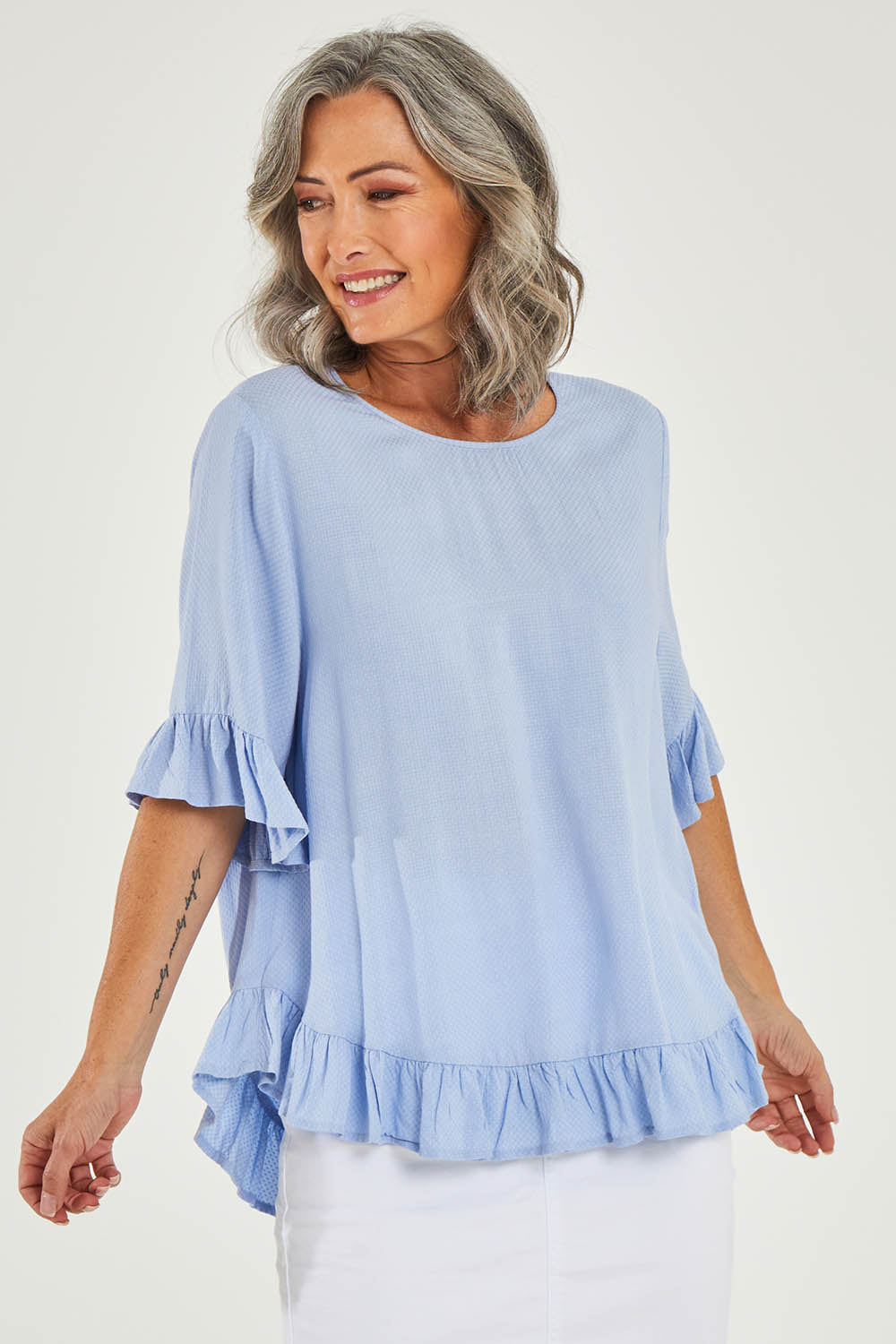 Model Luisa wearing size 10 of the Kiara Top in colour Skyblue (Blue), from the front, cropped image