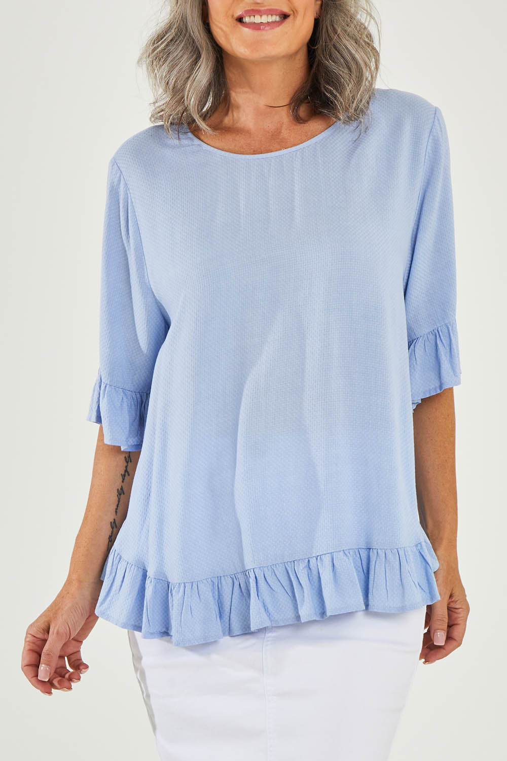 Model Luisa wearing size 10 of the Kiara Top in colour Skyblue (Blue), from the front, cropped image