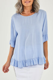 Model Luisa wearing size 10 of the Kiara Top in colour Skyblue (Blue), from the front, cropped image
