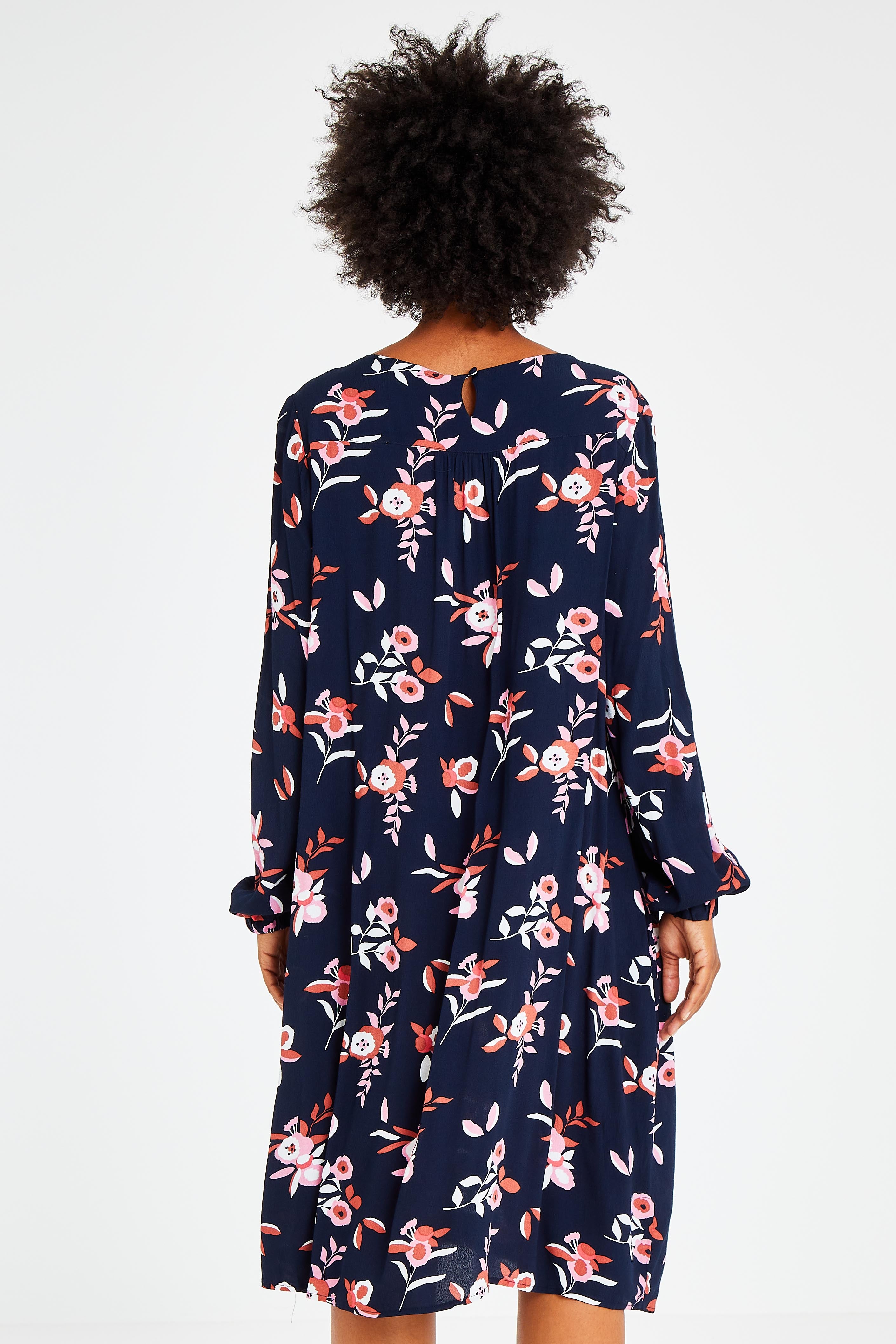 Model Olivia wearing size 10 of the Sloanne Floral Dress in colour Navy (Blue), from the back