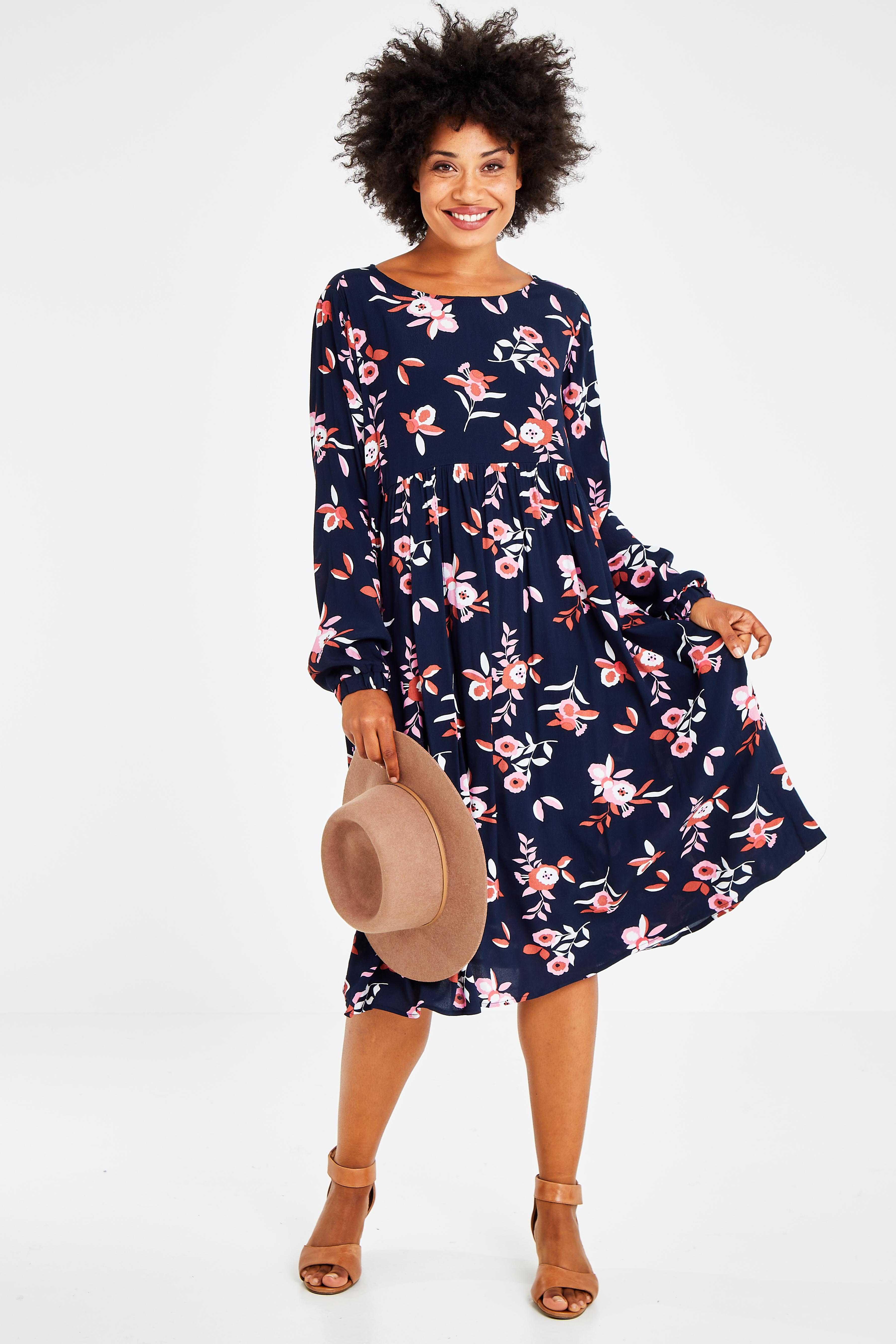 Model Olivia wearing size 10 of the Sloanne Floral Dress in colour Navy (Blue), from the front, showing the whole outfit