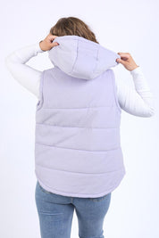 A model wearing the Cord Puffer Vest in colour Dustylila (Purple), from the back