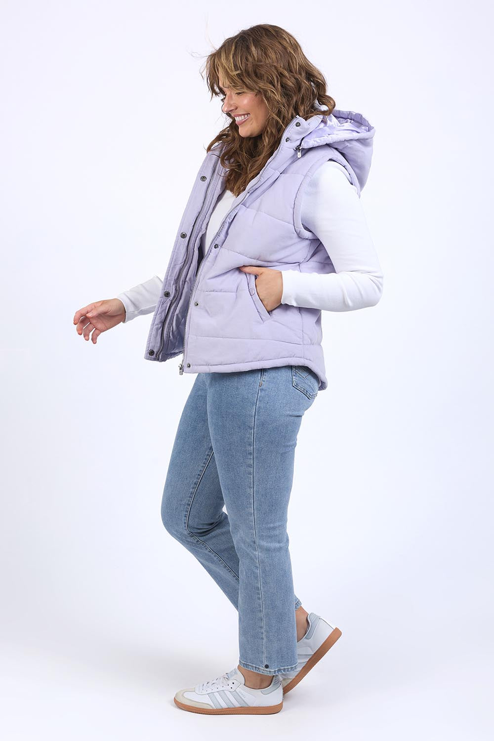 A model wearing the Cord Puffer Vest in colour Dustylila (Purple), from the front, showing the whole outfit
