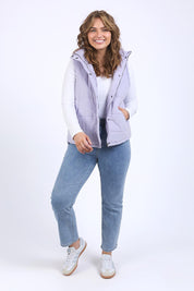 A model wearing the Cord Puffer Vest in colour Dustylila (Purple), from the front, showing the whole outfit