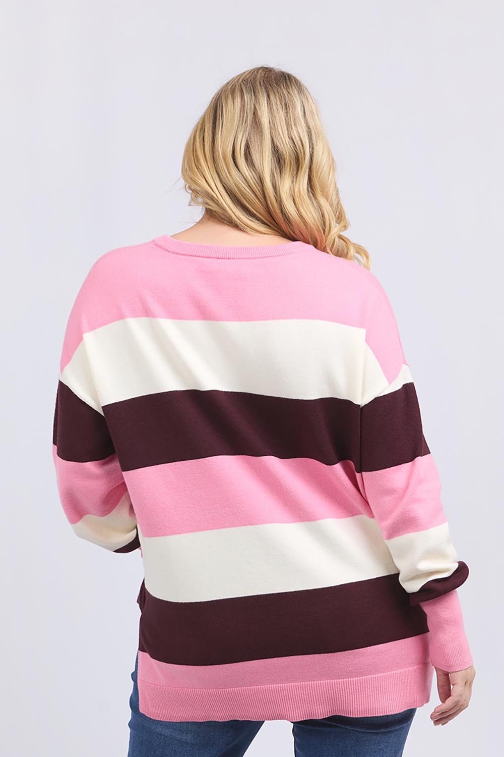 A model wearing the Hallie Stripe Knit in colour Pinkmarsh, from the back