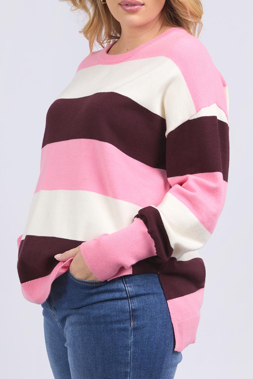 A model wearing the Hallie Stripe Knit in colour Pinkmarsh, from the front, cropped image