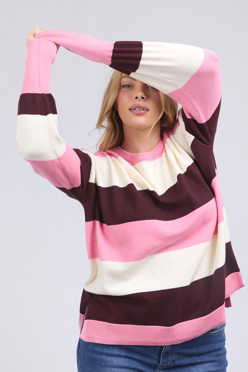 A model wearing the Hallie Stripe Knit in colour Pinkmarsh, from the front, cropped image