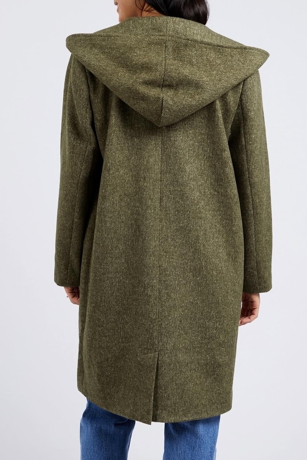 A model wearing the Jordan Coat in colour Clover (Green), from the back