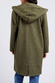 A model wearing the Jordan Coat in colour Clover (Green), from the back