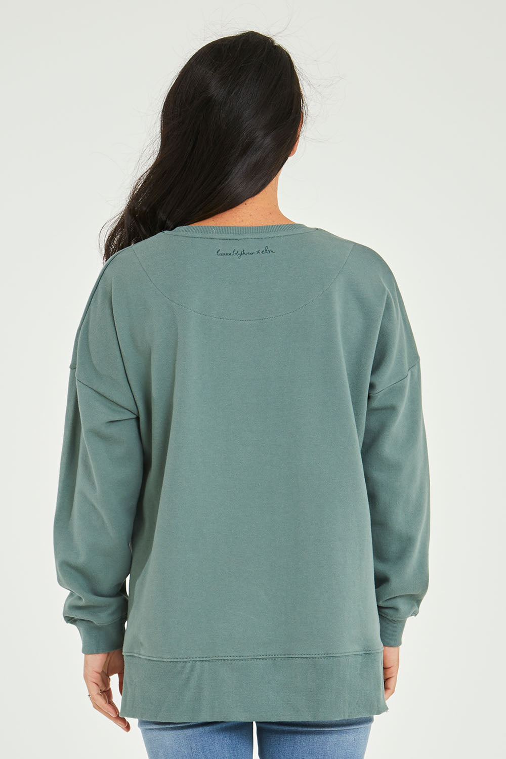 Model Katie wearing size 10 of the Laura Wombat Crew in colour Seapine (Green), from the back