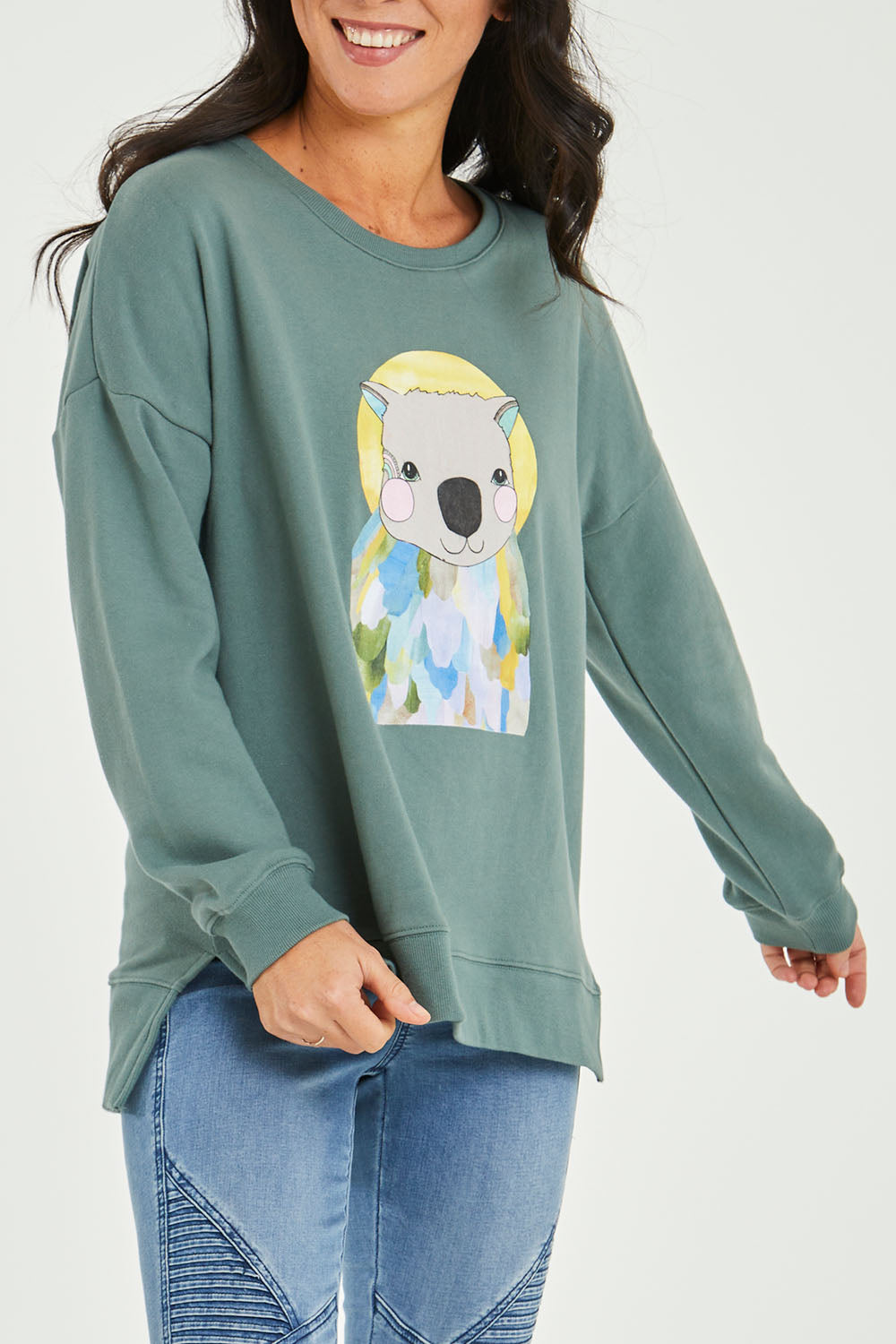 Model Katie wearing size 10 of the Laura Wombat Crew in colour Seapine (Green), from the front, cropped image