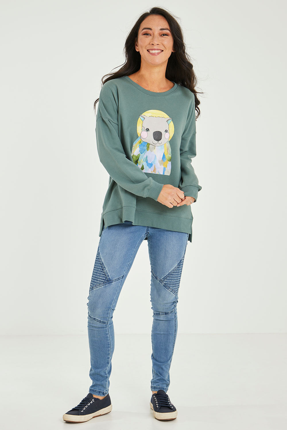 Model Katie wearing size 10 of the Laura Wombat Crew in colour Seapine (Green), from the front, showing the whole outfit
