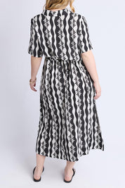 A model wearing the Casa Dress in colour Blackmarsh (Black), from the back
