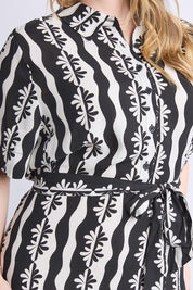 A model wearing the Casa Dress in colour Blackmarsh (Black), from the front, cropped image