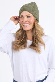 A model wearing the Forrest Beanie in colour Leafclover (Green), from the front, cropped image