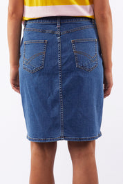 A model wearing the Chloe Denim Skirt in colour Midblue (Blue), from the back