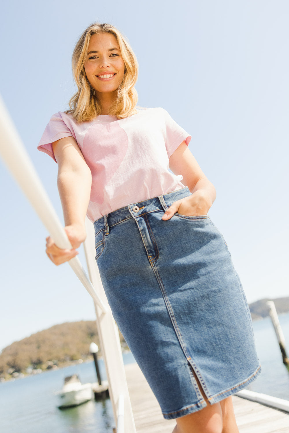 Model Phoebe wearing size 10 of the Chloe Denim Skirt in colour Midblue (Blue), from the front, showing the whole outfit