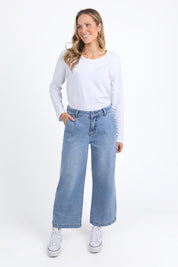 A model wearing the Izzy Wide Leg Jean in colour Lightblue (Blue), from the front, showing the whole outfit