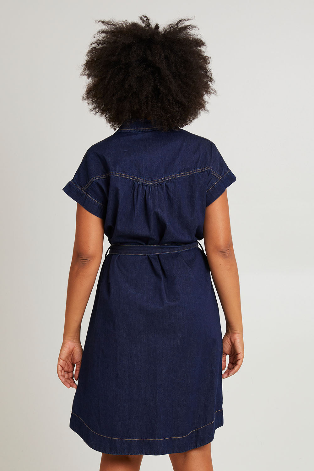 Model Olivia wearing size 10 of the Everleigh Denim Dress in colour Drkwash (Blue), from the back