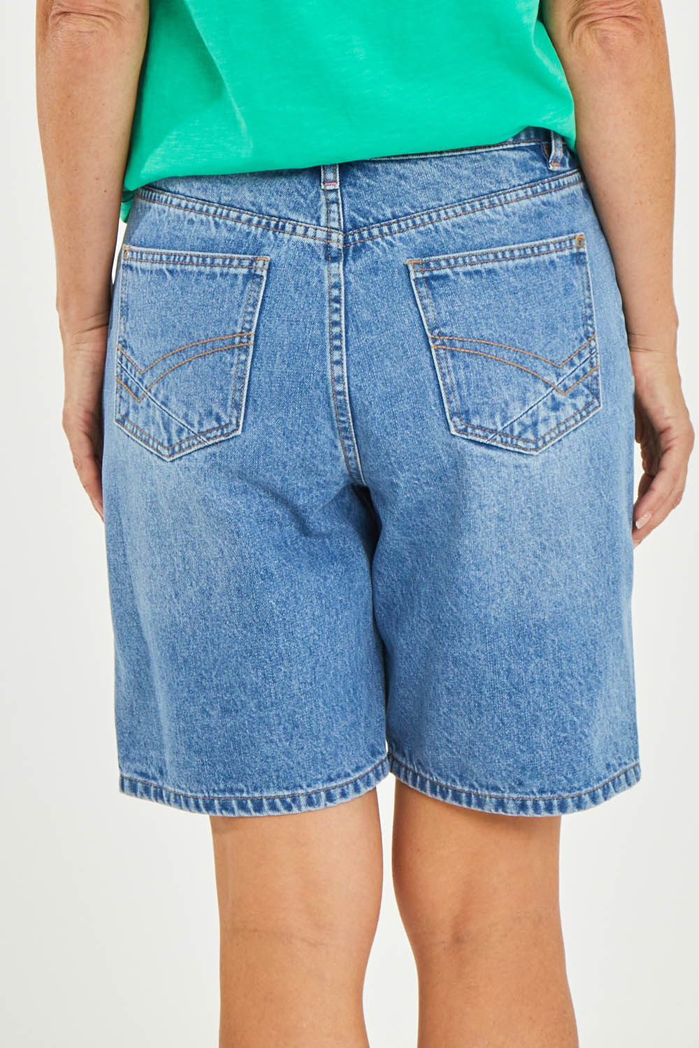 Model Luisa wearing size 10 of the Eden Denim Shorts in colour Denim (Blue), from the back