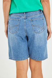 Model Luisa wearing size 10 of the Eden Denim Shorts in colour Denim (Blue), from the back