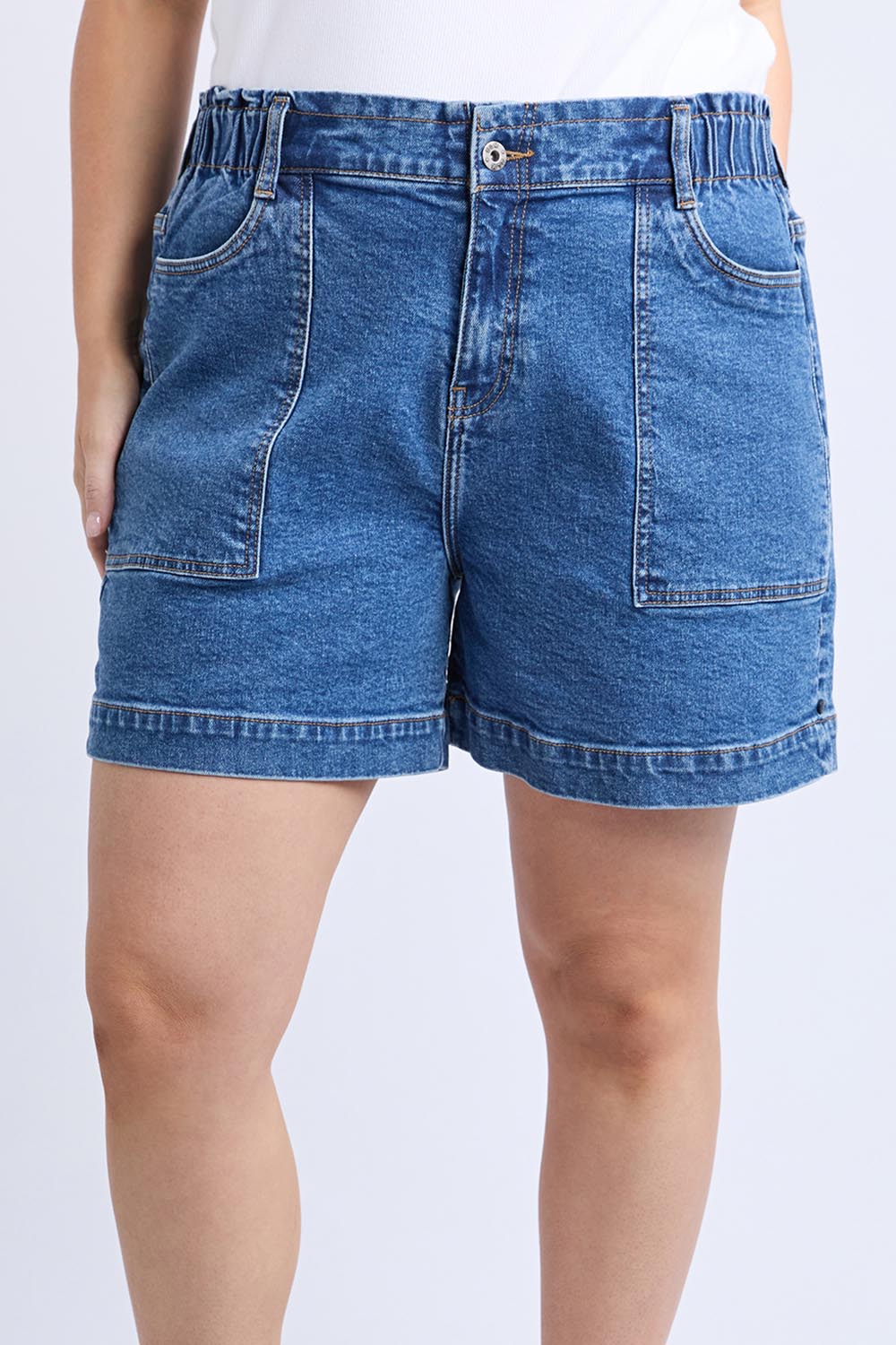 A model wearing the Fundamental Atlas Denim Short in colour Darkblue (Blue), from the front, cropped image