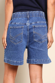 Model Pamelar wearing size 10 of the Fundamental Atlas Denim Short - Darkblue in colour Darkblue, from the back