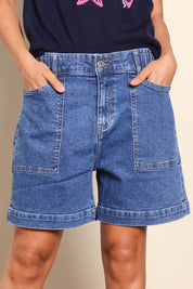 Model Pamelar wearing size 10 of the Fundamental Atlas Denim Short - Darkblue in colour Darkblue, in a cropped view