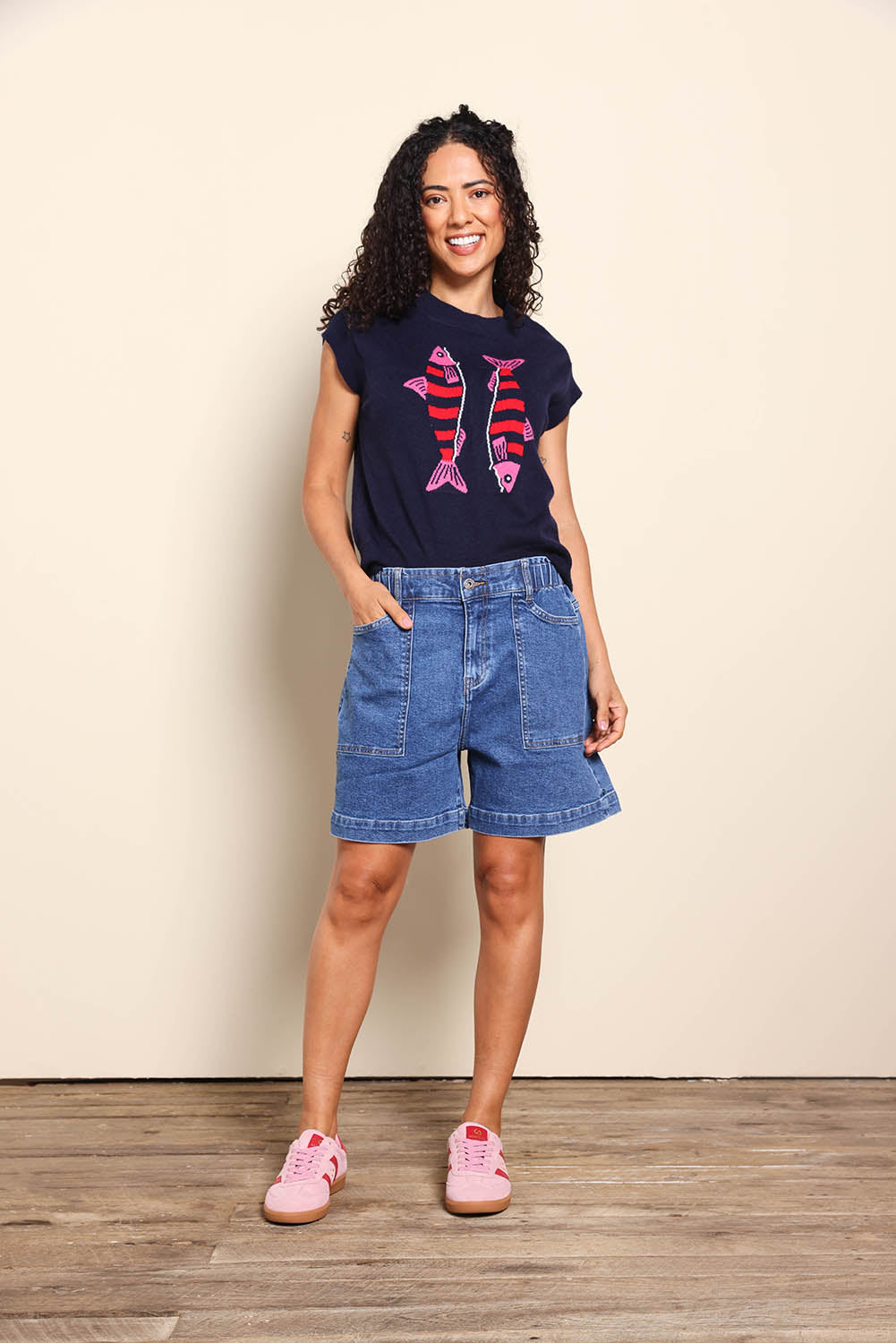 Model Pamelar wearing size 10 of the Fundamental Atlas Denim Short - Darkblue in colour Darkblue, from the front