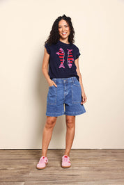 Model Pamelar wearing size 10 of the Fundamental Atlas Denim Short - Darkblue in colour Darkblue, from the front