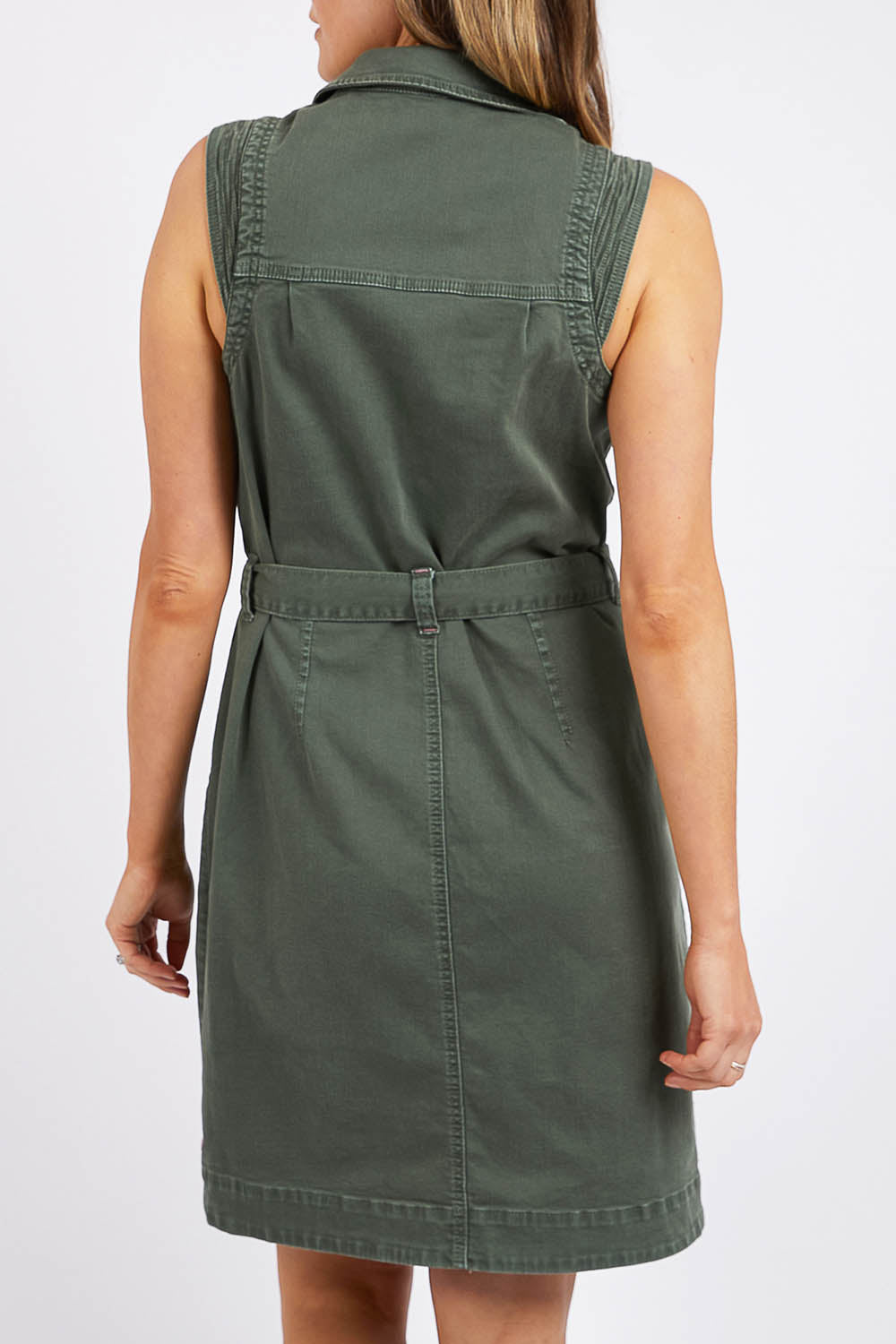 A model wearing the Marigold Denim Dress in colour Clover (Green), from the front, cropped image