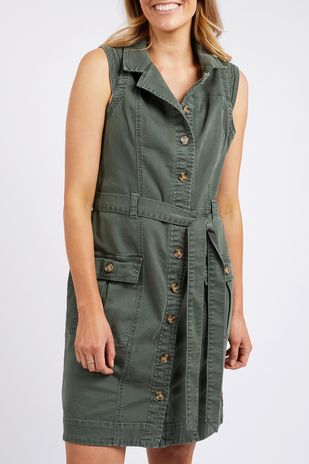 A model wearing the Marigold Denim Dress in colour Clover (Green), from the front, cropped image