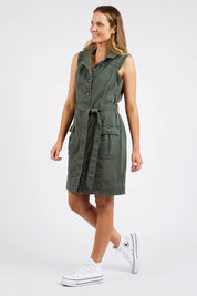 A model wearing the Marigold Denim Dress in colour Clover (Green), from the front, showing the whole outfit