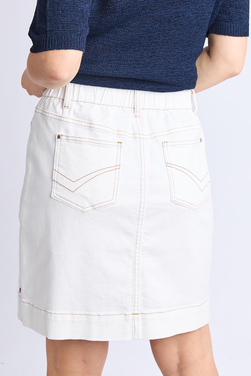 A model wearing the Atlas Denim Skirt in colour Vintwhite (White), from the back