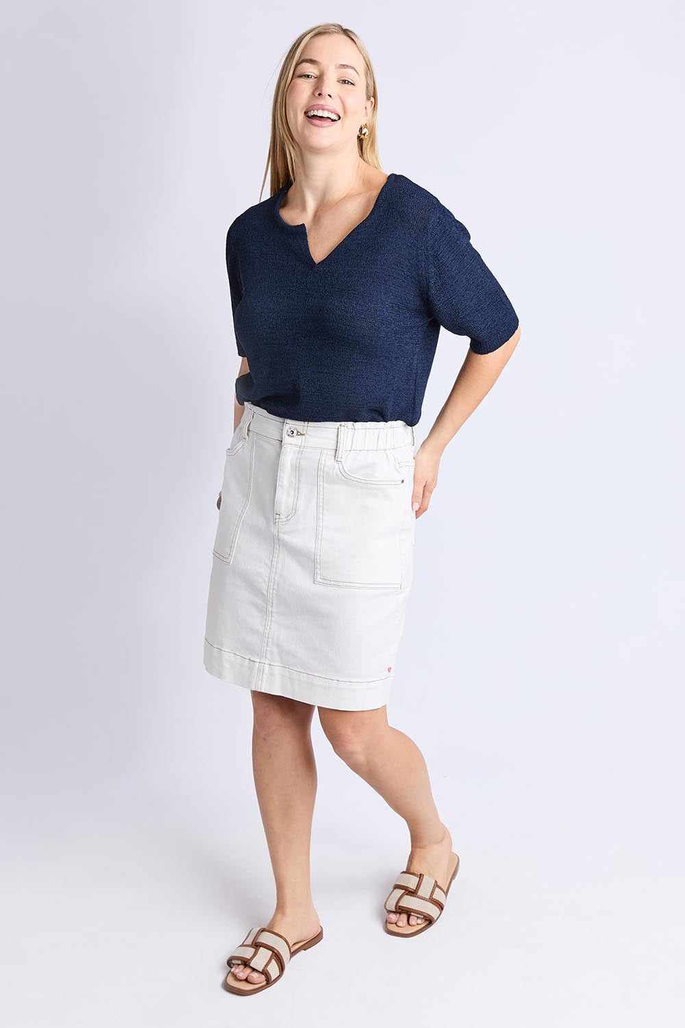 A model wearing the Atlas Denim Skirt in colour Vintwhite (White), from the front, showing the whole outfit