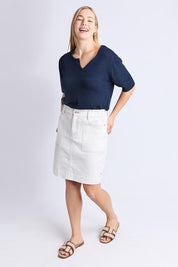 A model wearing the Atlas Denim Skirt in colour Vintwhite (White), from the front, showing the whole outfit
