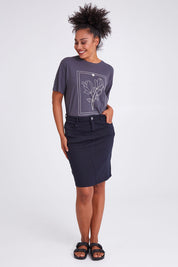 Model Olivia wearing size 10 of the Belle Denim Skirt in colour Washeblack (Black), from the front, showing the whole outfit