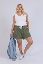 Model Genericm wearing size sample of the Fundamental Emma Relaxed Denim Short – Clover in colour Clover, from the front
